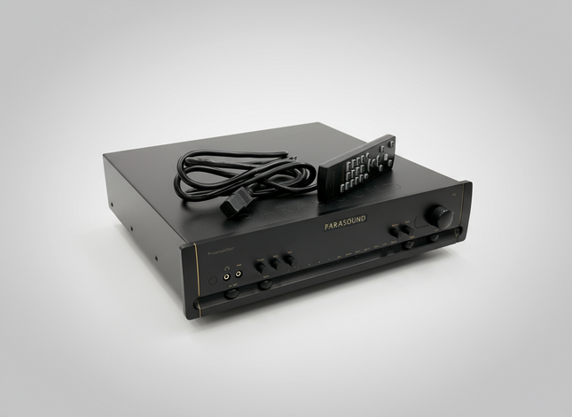 Parasound Halo P6 with remote and power cord over grey background.